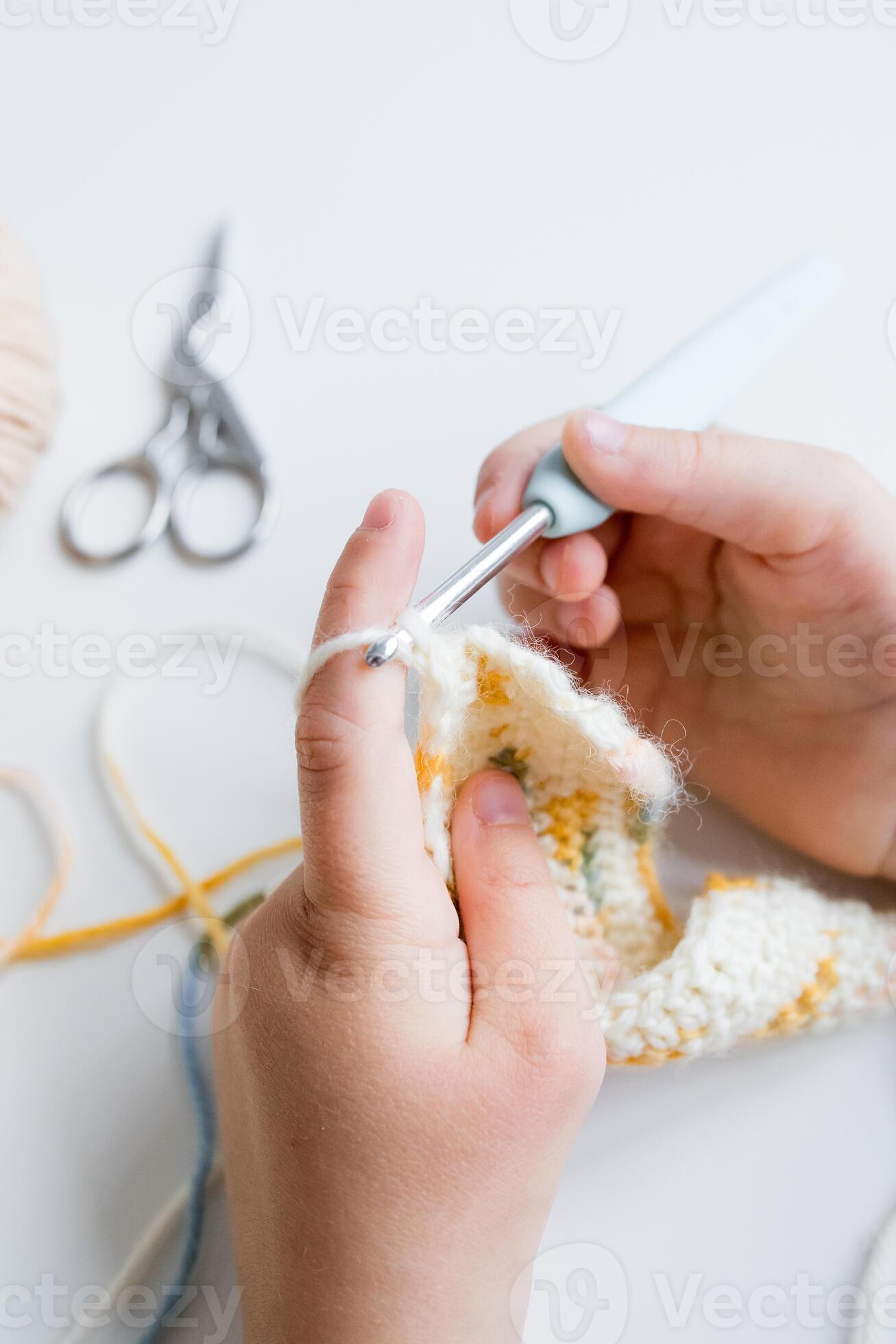 Close up of hands crocheting a colorful pattern with crochet hook and yarn  61377019 Stock Photo at Vecteezy